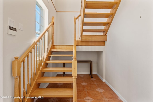 stairway with tile patterned flooring