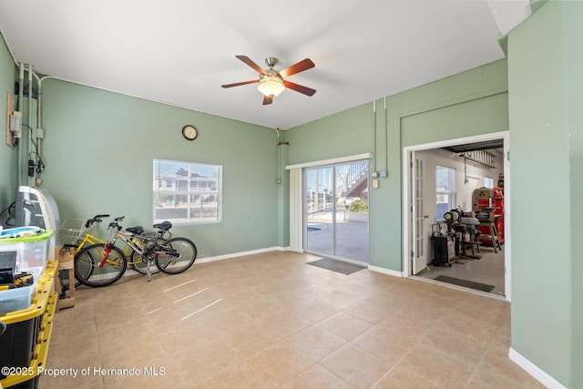 interior space with ceiling fan