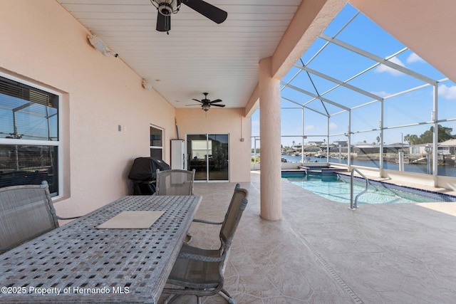 view of pool featuring a patio, a lanai, grilling area, ceiling fan, and a water view