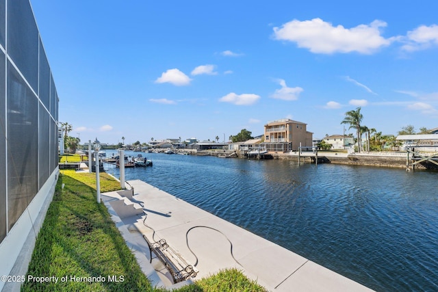 dock area with a water view and glass enclosure