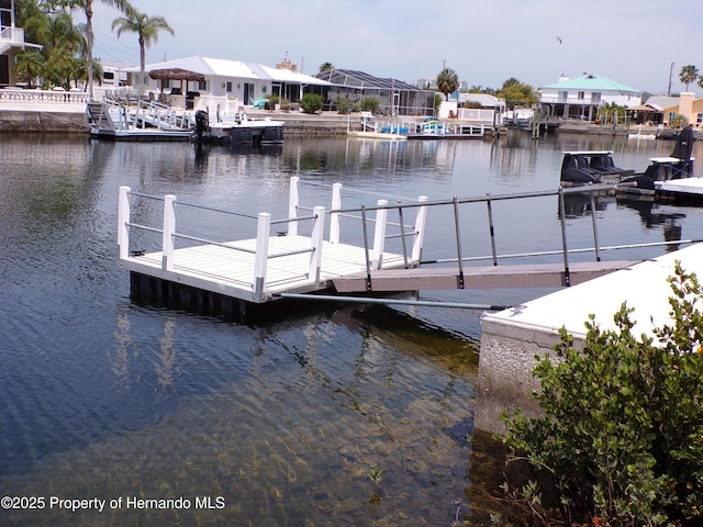 view of dock featuring a residential view and a water view