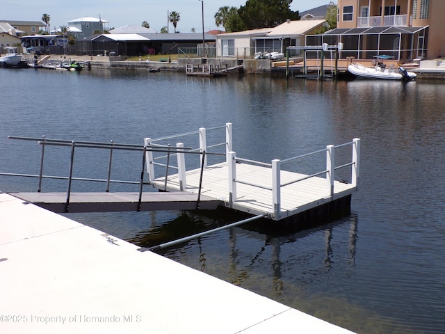 view of dock with a residential view and a water view