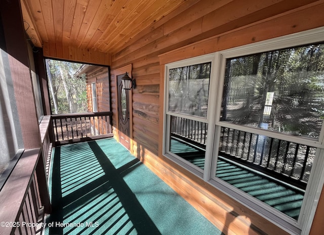 unfurnished sunroom with wooden ceiling