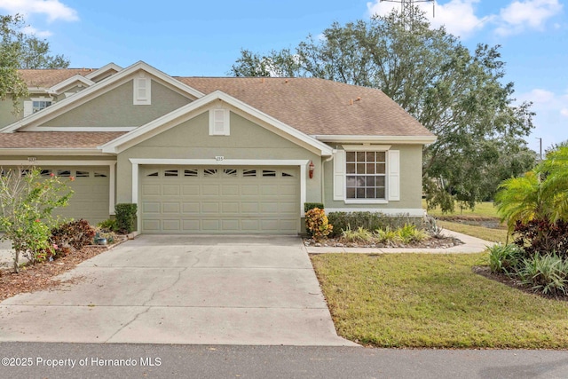 view of front of house with a front yard and a garage