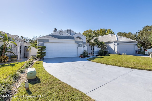 single story home with a garage and a front lawn