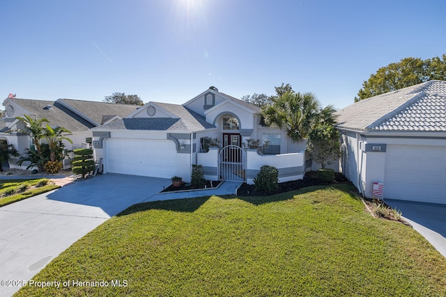 ranch-style home featuring a front lawn and a garage