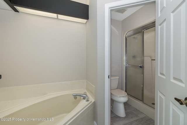 bathroom featuring toilet and separate shower and tub