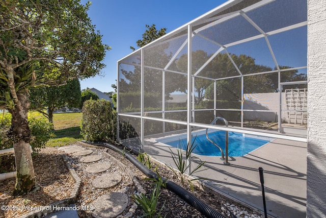 view of swimming pool with glass enclosure and a patio area