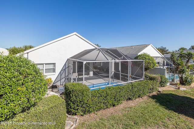 rear view of property with glass enclosure