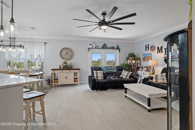 living room with light hardwood / wood-style flooring, plenty of natural light, crown molding, and ceiling fan