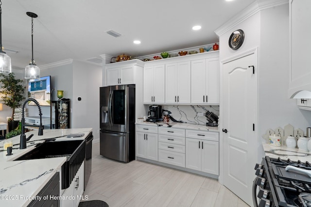 kitchen featuring pendant lighting, crown molding, light stone countertops, appliances with stainless steel finishes, and white cabinetry