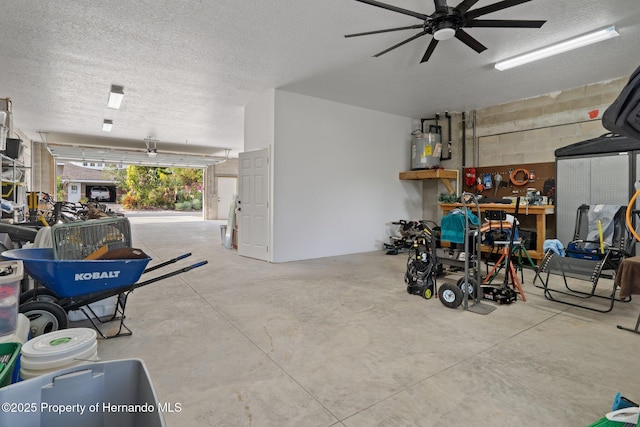 garage with a workshop area, ceiling fan, and gas water heater