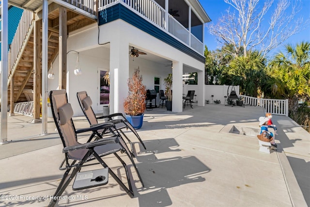 view of patio with a balcony and ceiling fan