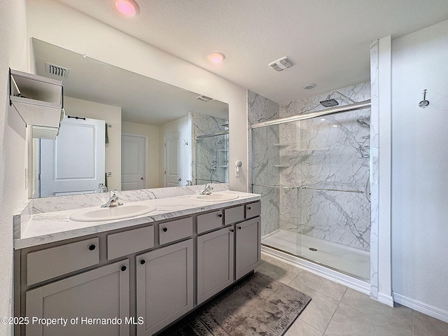 bathroom with tile patterned floors, vanity, and a shower with shower door