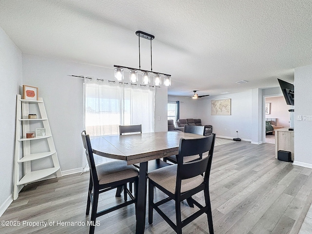 3337 Autumn Amber Dr, Spring Hill, FL 34609 - dining area featuring light wood-style floors, a textured ceiling, and ceiling fan