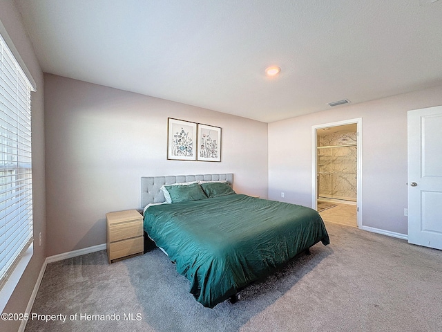 carpeted bedroom with connected bathroom