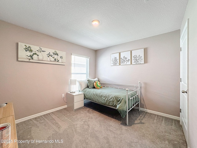 bedroom with a textured ceiling and carpet floors