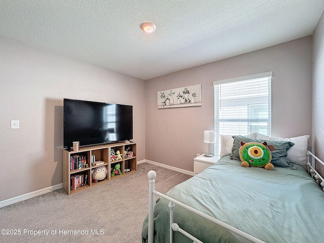 bedroom featuring carpet floors and a textured ceiling