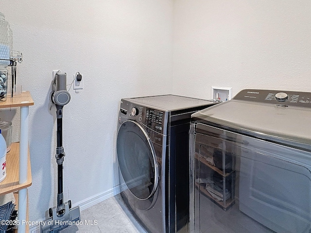 laundry area featuring washing machine and clothes dryer