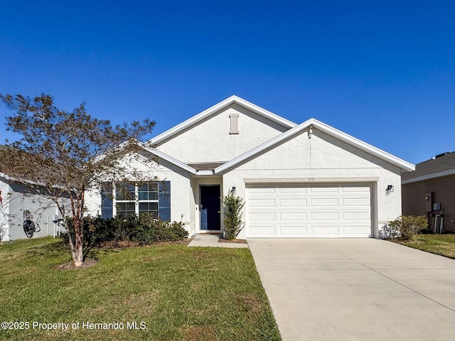 3337 Autumn Amber Dr, Spring Hill, FL 34609 - ranch-style home featuring stucco siding, a front lawn, concrete driveway, and a garage