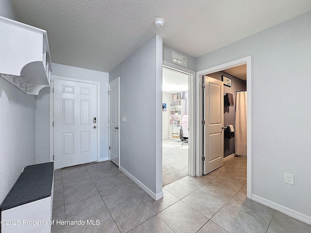3337 Autumn Amber Dr, Spring Hill, FL 34609 - foyer featuring light tile patterned floors and a textured ceiling