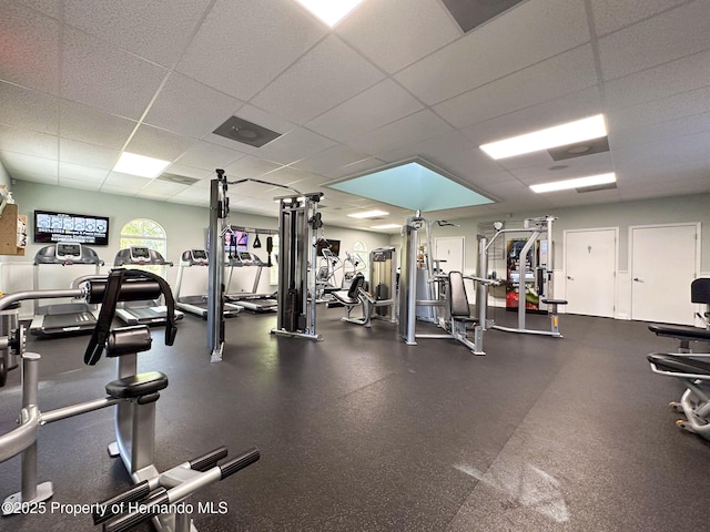 gym featuring a paneled ceiling