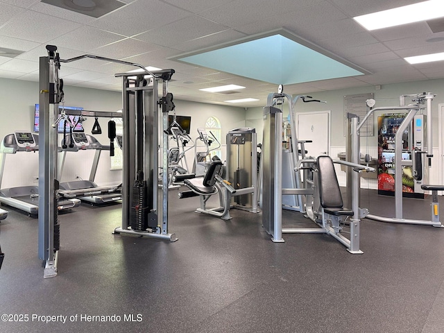 gym with a paneled ceiling