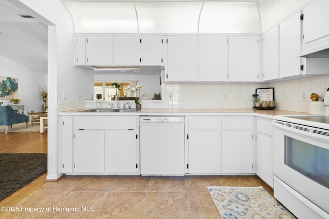 kitchen featuring tasteful backsplash, white cabinetry, sink, and white appliances