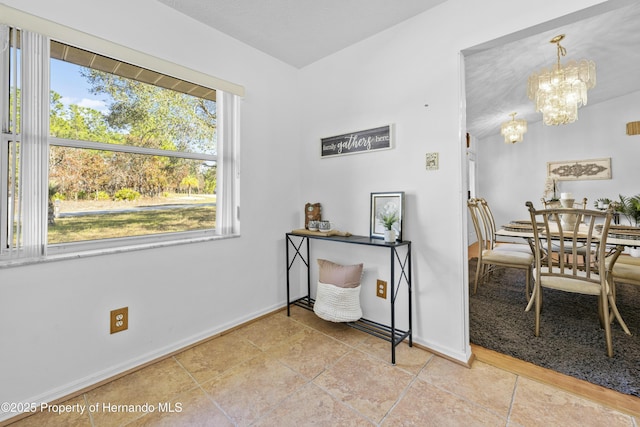 interior space with a notable chandelier and light tile patterned flooring