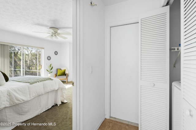 bedroom with ceiling fan, a closet, and a textured ceiling