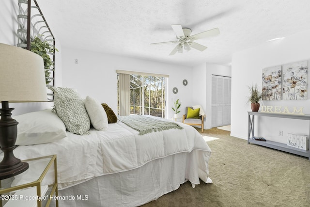 bedroom with carpet flooring, a textured ceiling, access to outside, ceiling fan, and a closet