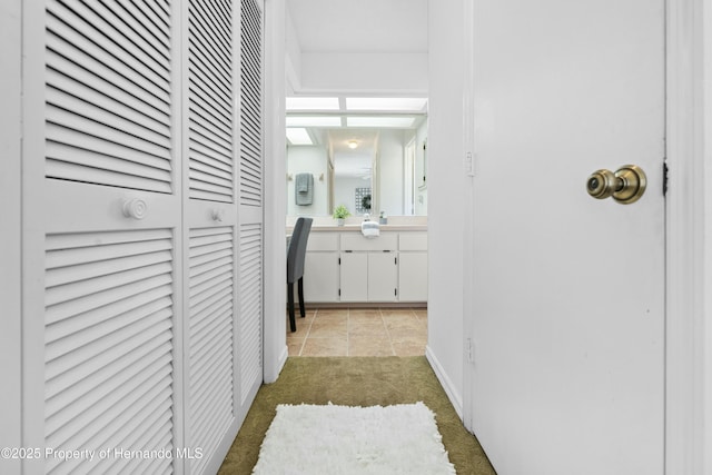 corridor featuring light colored carpet