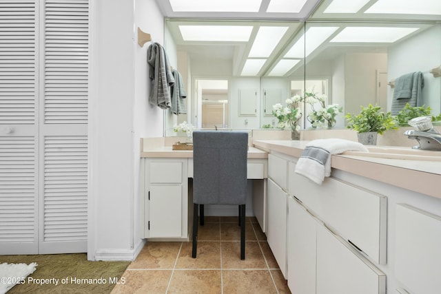 bathroom featuring tile patterned flooring, a shower with shower door, and sink