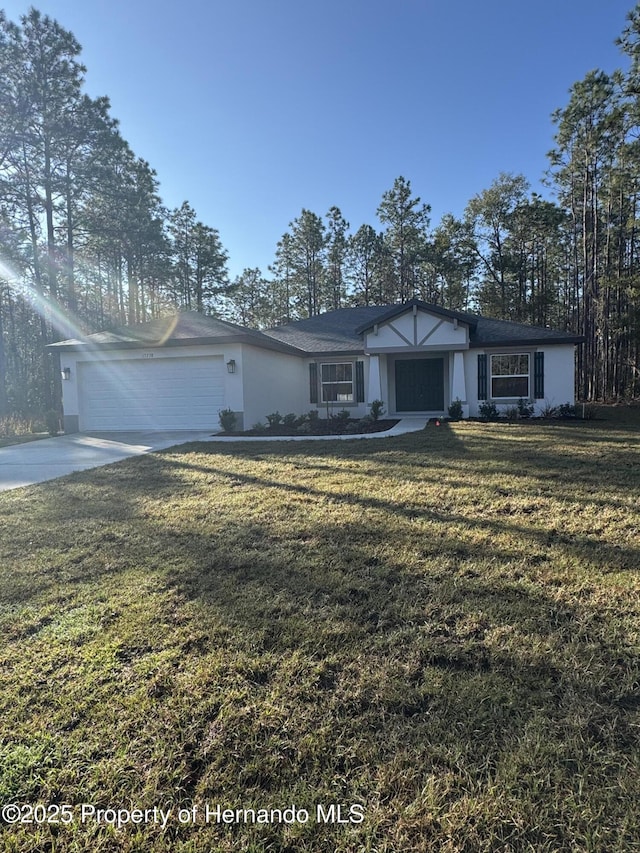 view of front of property featuring a garage and a front lawn