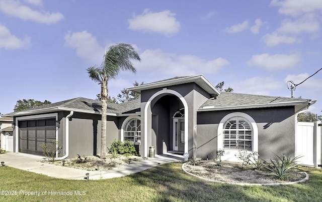 view of front of home with a front lawn and a garage