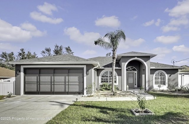 view of front facade with a front yard and a garage