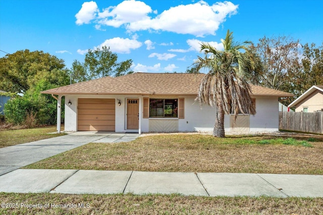 single story home featuring a front lawn and a garage