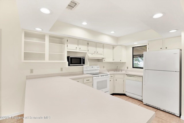 kitchen featuring white cabinetry, sink, light tile patterned floors, and white appliances