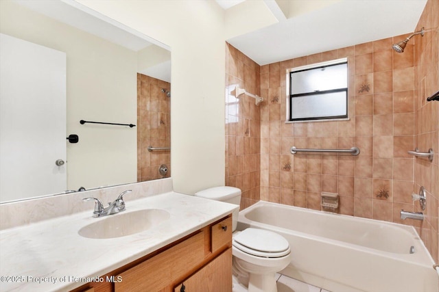 full bathroom featuring vanity, toilet, and tiled shower / bath