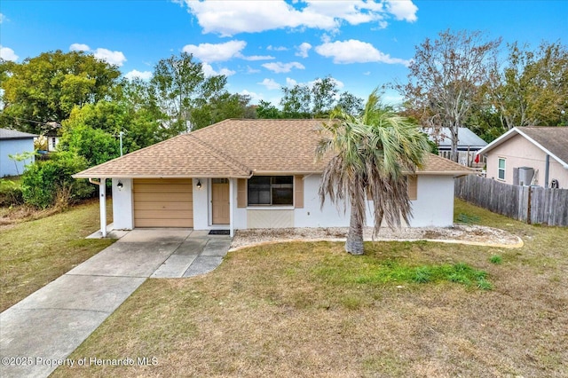 single story home featuring a garage and a front lawn