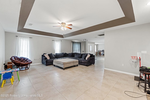 37351 Neighbors Path, Zephyrhills, FL 33542 - living room featuring a raised ceiling, ceiling fan, and light tile patterned floors