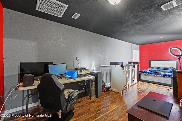 37351 Neighbors Path, Zephyrhills, FL 33542 - bedroom with a textured ceiling and dark hardwood / wood-style flooring