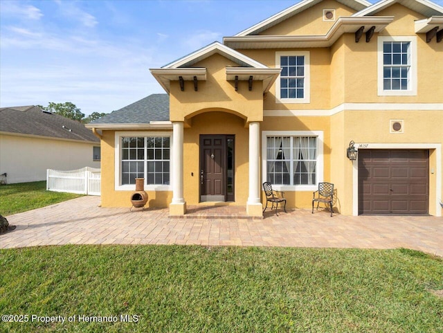 view of front of house with a garage and a front yard