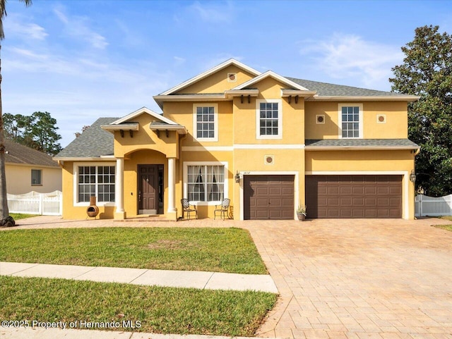 view of front of house with a front lawn and a garage