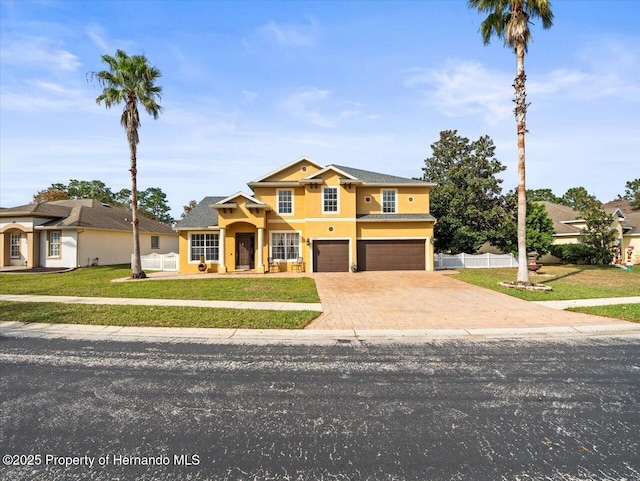 view of front facade with a front yard and a garage