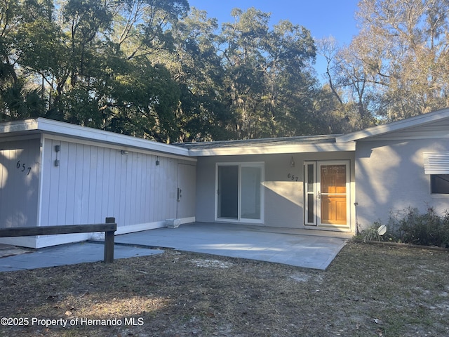 back of property with a patio