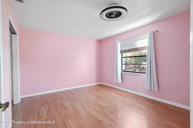 empty room with light hardwood / wood-style floors