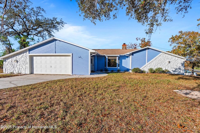 ranch-style house featuring a garage and a front yard