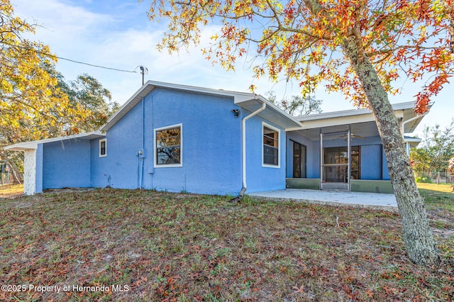 rear view of property featuring a patio area and a sunroom