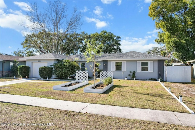 ranch-style home with a garage and a front lawn